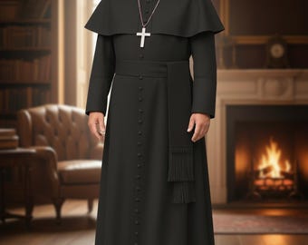 May include: Black clerical cassock with a matching cape and sash. The long-sleeved garment features a row of buttons down the front and a white cross pendant. The outfit is worn with a white clerical collar.