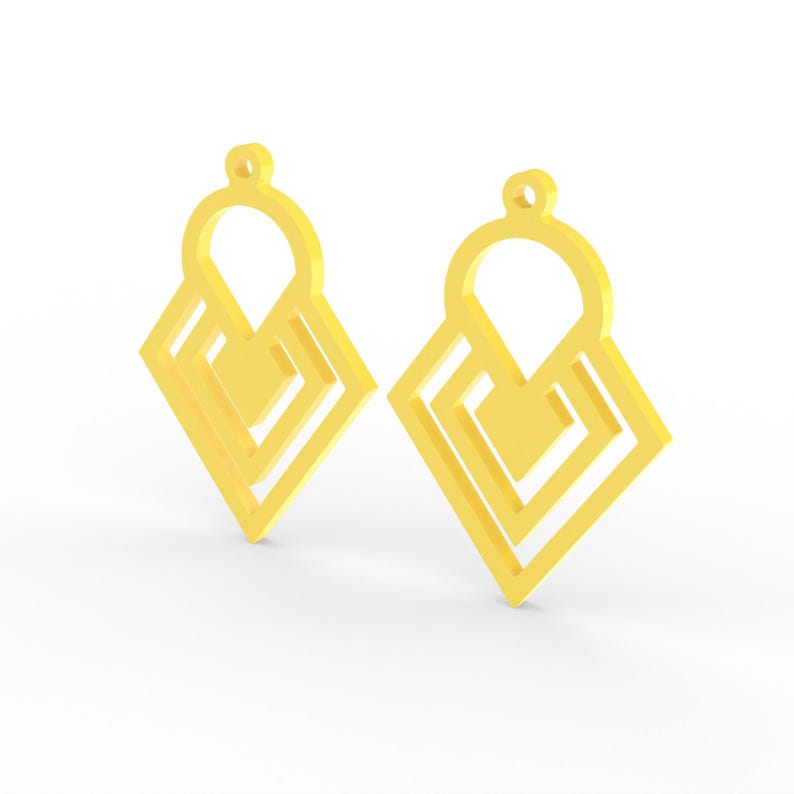 May include: Two gold-colored geometric earrings. Each earring features a diamond-shaped design with layered squares and a circular top loop for hanging. The earrings are displayed against a white background.