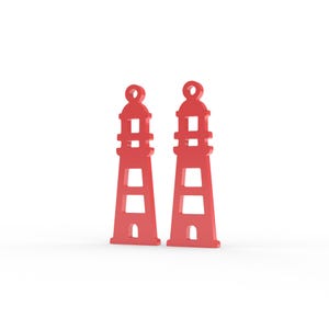 Puede incluir: Dos dijes id&eacute;nticos en forma de faro de color rojo, cada uno con un lazo circular en la parte superior, un cuerpo c&oacute;nico con recortes horizontales y una peque&ntilde;a abertura arqueada en la base, presentados como un par de componentes planos.
