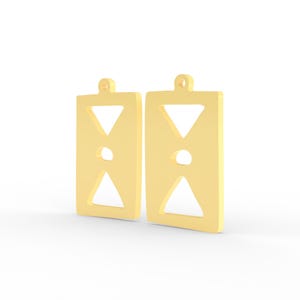 May include: Two gold-colored earrings. Each earring is rectangular with a small loop at the top for hanging. The design includes a downward-pointing triangle at the top, a circular cutout in the middle, and an upward-pointing triangle at the bottom.
