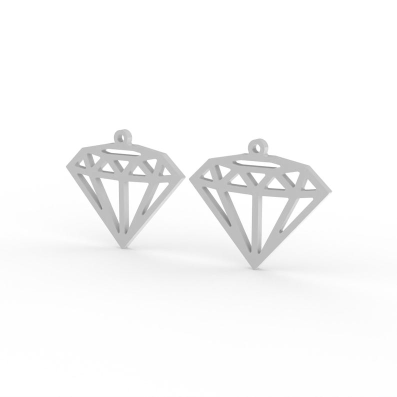 May include: Two silver-colored diamond-shaped pendants. Each pendant has a geometric design with multiple facets and a small loop at the top for hanging. The pendants are displayed against a white background.