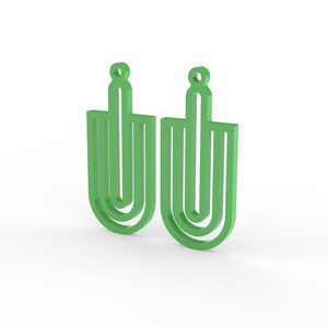 May include: Two green earrings with a geometric design. Each earring has a loop at the top for hanging and a U-shaped design with vertical lines. The earrings are a bright, solid green color and are set against a white background.