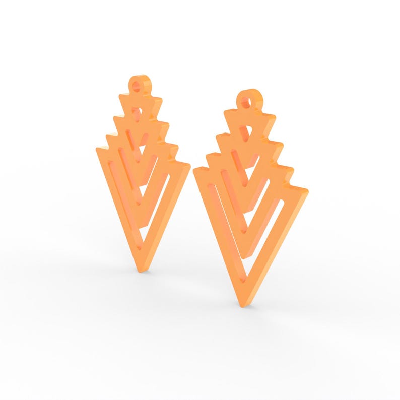 May include: Two orange geometric earrings with a layered, open design. Each earring features a series of stacked, inverted triangles, creating a unique, modern look. The earrings have a small loop at the top for hanging.