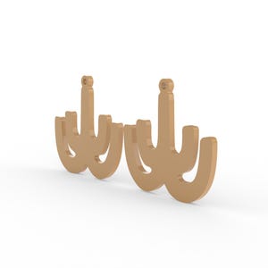 May include: Two light brown chandelier-shaped earrings. Each earring has a vertical post with a small loop at the top, and three curved arms extending downwards. The earrings are set against a white background.