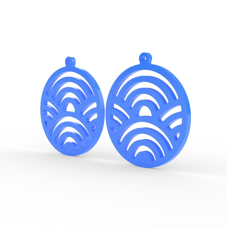 May include: Two blue, circular earrings with a wave-like pattern cut out of the center. Each earring has a small loop at the top for hanging. The earrings are displayed against a white background.