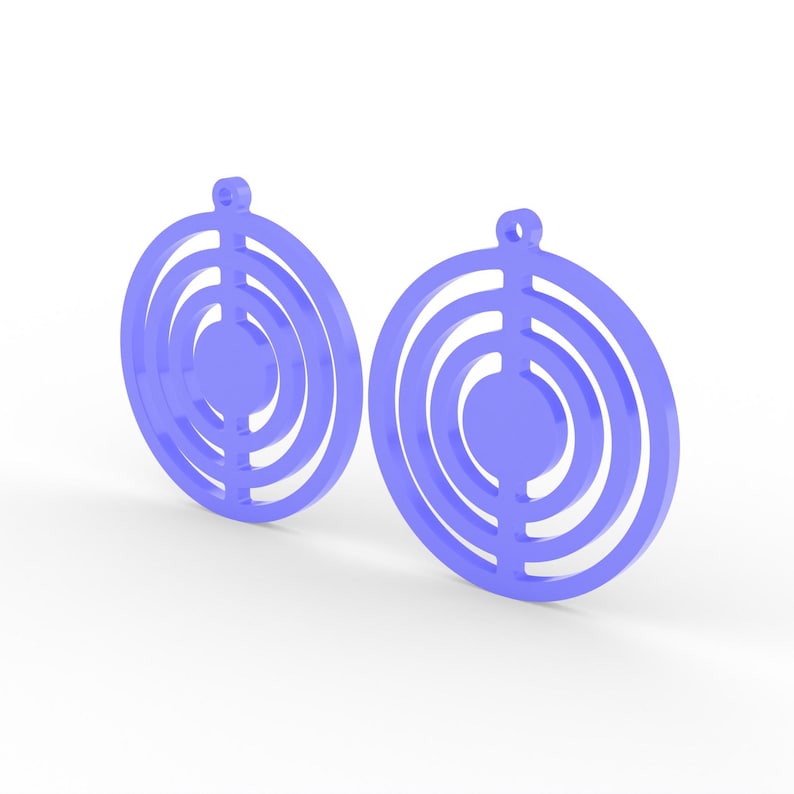 May include: Two light purple earrings with a circular design. Each earring features concentric circles with a solid center and a small loop at the top for hanging. The earrings are set against a white background.