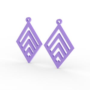 May include: Two lavender-colored diamond-shaped earrings. Each earring features a geometric design with layered chevron patterns. The earrings have a small loop at the top for hanging. The background is white.