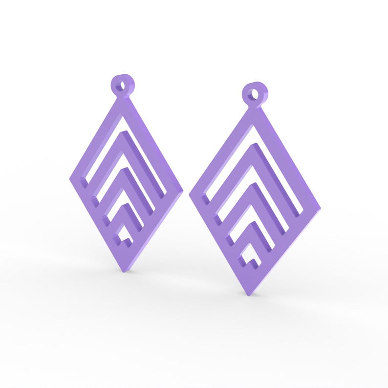 May include: Two lavender-colored diamond-shaped earrings. Each earring features a geometric design with layered chevron patterns. The earrings have a small loop at the top for hanging. The background is white.