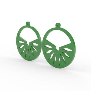 May include: A pair of green, circular earrings. Each earring features a semi-circular top and a sunburst design at the bottom. The earrings are made of a solid material and have a small loop at the top for hanging.