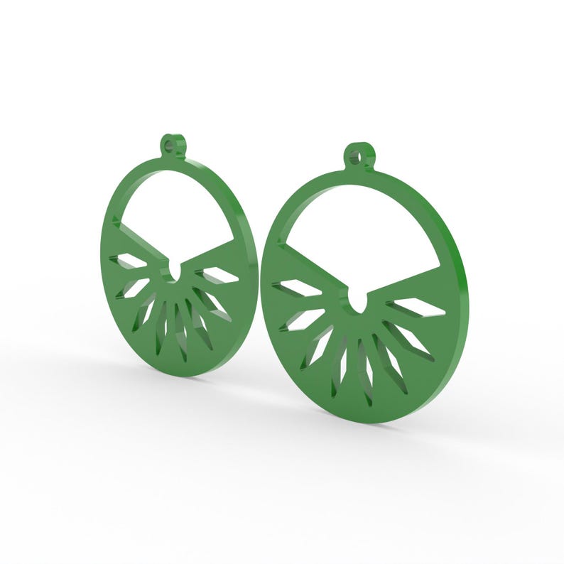 May include: A pair of green, circular earrings. Each earring features a semi-circular top and a sunburst design at the bottom. The earrings are made of a solid material and have a small loop at the top for hanging.