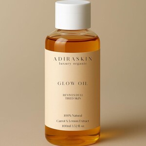 May include: A clear glass bottle of Glow Oil with a white cap. The label reads "ADIRASKIN luxury organic" and "GLOW OIL". It also states "REVIVES DULL TIRED SKIN" and "100% Natural Carrot & Lemon Extract 100ml 3.52 fl. oz."