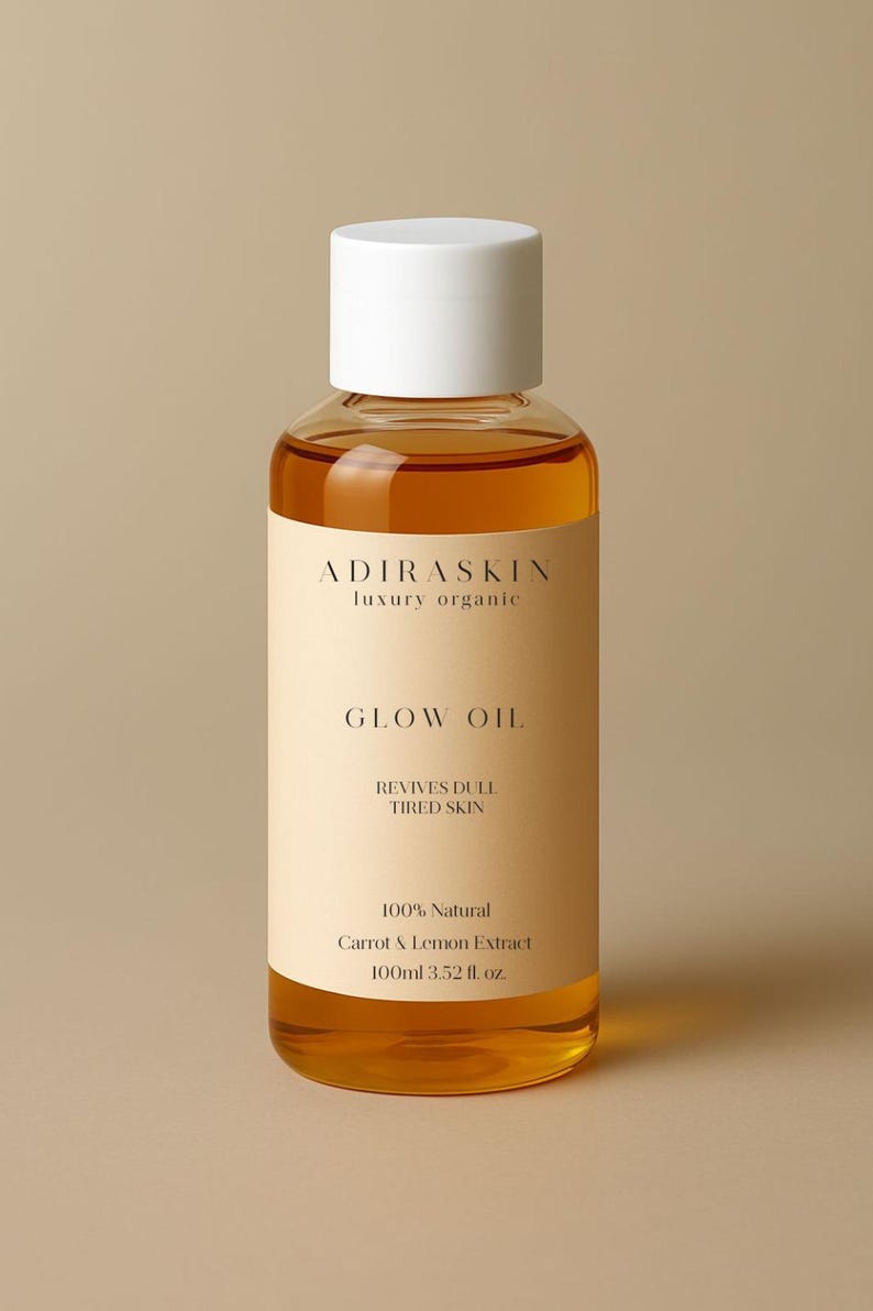 May include: A clear glass bottle of Glow Oil with a white cap. The label reads "ADIRASKIN luxury organic" and "GLOW OIL". It also states "REVIVES DULL TIRED SKIN" and "100% Natural Carrot & Lemon Extract 100ml 3.52 fl. oz."