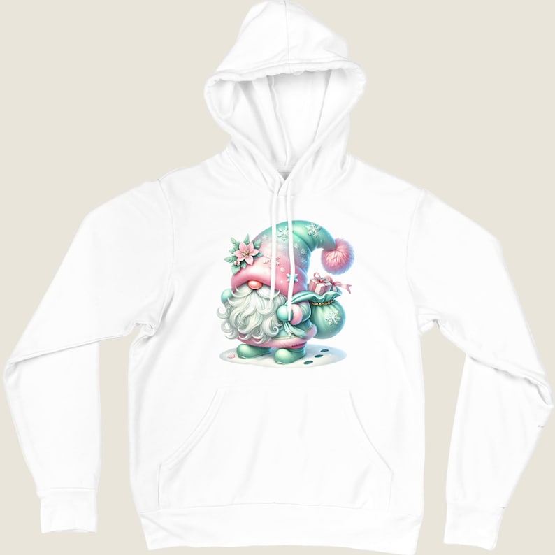 May include: White hooded sweatshirt featuring a whimsical gnome illustration. The gnome is depicted in pastel colors, wearing a hat and holding a gift bag. The design includes floral and snowflake accents, creating a festive and charming aesthetic.
