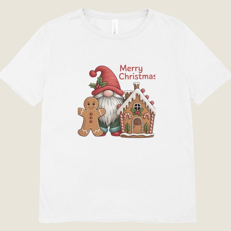 May include: White t-shirt featuring a Christmas gnome wearing a red hat and a gingerbread man. A gingerbread house with candy cane accents is also shown. The words "Merry Christmas" are printed in red.