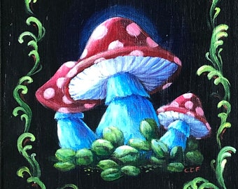 May include: A painting of three red and white mushrooms with blue stems on a black background with a green leafy border. The mushrooms are surrounded by green leaves. The painting is signed "CCF" in the bottom right corner.