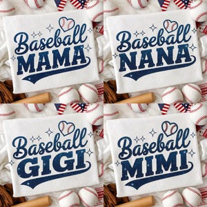 May include: Four white t-shirts with baseball-themed designs. Each shirt features the words "Baseball MAMA", "Baseball NANA", "Baseball GIGI", and "Baseball MIMI" in a navy blue, starry font, with a baseball heart graphic.