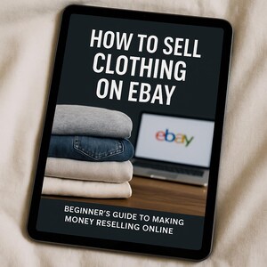 May include: A tablet displays the text "HOW TO SELL CLOTHING ON EBAY" in white, with a stack of folded clothing in the foreground. A laptop with the eBay logo is visible in the background. The text "BEGINNER'S GUIDE TO MAKING MONEY RESELLING ONLINE" is at the bottom.