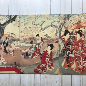 May include: A multi-panel Japanese woodblock print depicting a scene of people in traditional clothing under blossoming trees. The print features figures in colorful kimonos, a red bridge, and a parasol.
