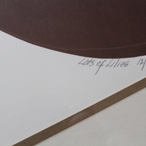 May include: A white paper with a brown circle and the text "Lots of Lilies 12/54" in black ink.