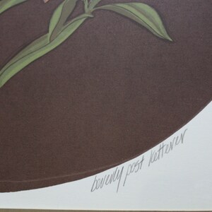 May include: A brown circle with a green plant and orange flowers. The signature "Beverly Post Ketterer" is written in cursive at the bottom of the circle.
