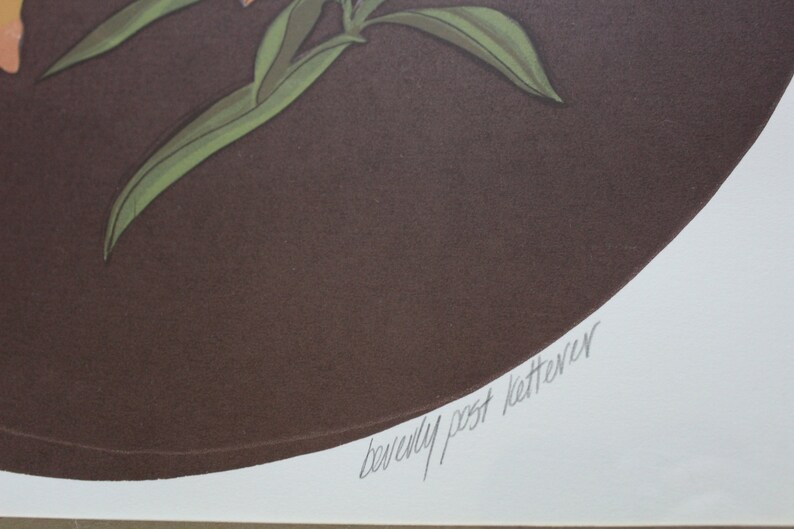 May include: A brown circle with a green plant and orange flowers. The signature "Beverly Post Ketterer" is written in cursive at the bottom of the circle.