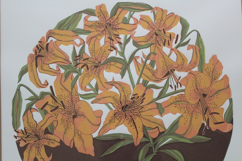 May include: A vintage print of a bouquet of orange lilies with brown stems and green leaves. The lilies are arranged in a circular pattern on a white background.