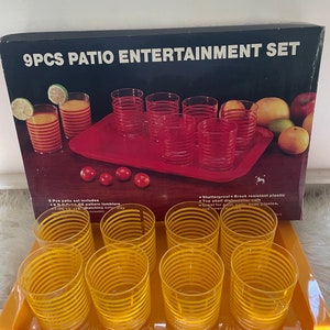 May include: A set of 9 yellow and white striped plastic tumblers with a matching yellow tray. The set is labeled "9PCS PATIO ENTERTAINMENT SET".