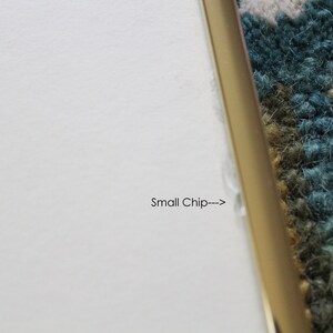 May include: Close-up of a white surface with a small chip on the edge, indicated by an arrow and the text "Small Chip---".