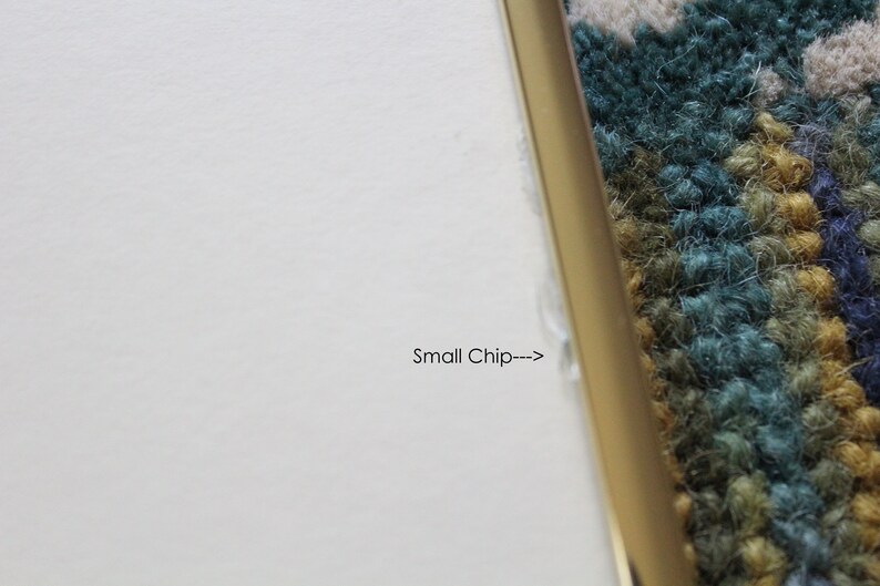 May include: Close-up of a white surface with a small chip on the edge, indicated by an arrow and the text "Small Chip---".