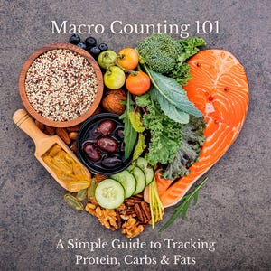 May include: A heart-shaped arrangement of healthy foods, including salmon, broccoli, quinoa, nuts, and olives. The image includes the text "Macro Counting 101" and "A Simple Guide to Tracking Protein, Carbs & Fats".