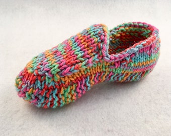 May include: A pair of colorful knitted slippers with a multi-colored yarn in shades of pink, orange, green, and blue.