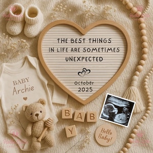 May include: A heart-shaped letter board with the text "THE BEST THINGS IN LIFE ARE SOMETIMES UNEXPECTED" and "October 2025". The image includes a baby onesie, a crochet teddy bear, baby booties, wooden blocks spelling "BABY", and a sonogram.