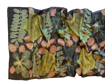 May include: A black silk scarf with a botanical print of leaves and flowers in shades of green, yellow, and brown.