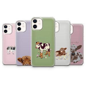 May include: A collection of phone cases with cow-themed designs. The cases feature illustrations of cows in various styles, including a cow wearing a cowboy hat, a Highland cow, and other cow-related graphics. The cases are in various colors, including pink, green, and purple.