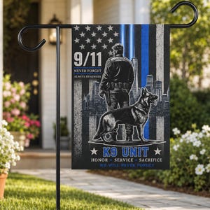 May include: A rectangular garden flag featuring a black and white illustration of a police officer and a German Shepherd dog standing before a city skyline. The design includes a blue vertical stripe, the text 9/11 NEVER FORGET, and K9 UNIT.