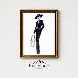 May include: A framed art print featuring a black and white sketch of a person in a stylish suit and hat, holding a lasso. The artwork is set against a white background and framed in a gold-toned frame. The "Rustwood Gallery" logo is at the bottom.