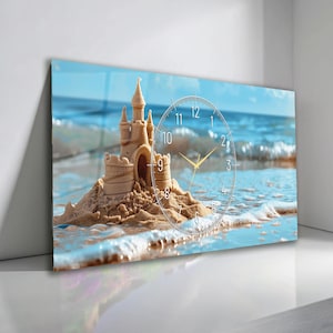 May include: A rectangular wall clock featuring a sandcastle on a beach with a blue ocean backdrop. The clock face is transparent with black numerals and gold hands. The sandcastle is beige, and the ocean is a mix of blue and white.