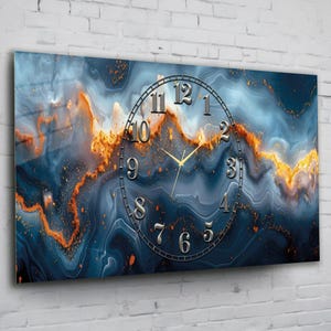 May include: A rectangular wall clock featuring a swirling abstract pattern of deep blue, grey, and vibrant orange hues. The clock face displays metallic silver numerals from 1 to 12 arranged in a circle, with matching silver hour and minute hands.