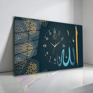 May include: A rectangular wall clock with a dark teal background. The clock face features Arabic numerals and gold hands. The design includes gold geometric patterns and the Arabic word "Allah" in a stylized font.
