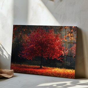 Peut inclure: Une impression murale rectangulaire représentant un arbre aux feuilles rouge vif et denses au milieu d'une forêt sombre. Le sol est recouvert d'une épaisse couche de feuilles mortes rouges et orange, créant un contraste avec des ombres profondes.
