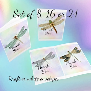May include: Set of 8, 16, or 24 thank you cards featuring watercolor dragonfly illustrations. The cards have a rainbow watercolor background and the text "Thank You" printed on each card. Kraft or white envelopes are included.