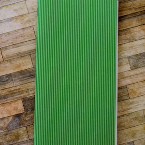May include: A green notebook with white vertical stripes and the text "Diana M. Larson" printed on the bottom.