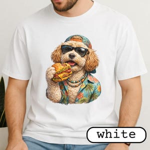 May include: White t-shirt featuring a cartoon dog wearing sunglasses, a hat, and a Hawaiian shirt, eating a burger. The dog has a beaded necklace. The word "white" is in a black outlined box at the bottom.