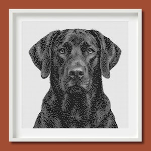 May include: A black and white stippled illustration of a Labrador Retriever dog head and shoulders, presented in a square white frame. The artwork uses dense black dots on a white background to create the detailed texture of the dog's fur.