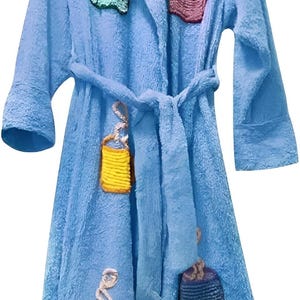 May include: A light blue terry cloth robe with a matching belt. The robe is decorated with embroidered coffee cup designs in various colors, including pink, green, yellow, and blue. The robe has long sleeves.