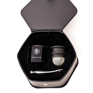 Black Carbon by Charlie grinder set displayed inside a hexagon storage case with a mesh insert and metal tool.