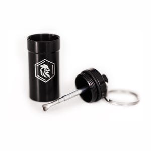 May include: Black metal container with a silver rooster logo and a matching tool. The tool is attached to a black cap with a keyring. The container is cylindrical and has a screw-on cap.