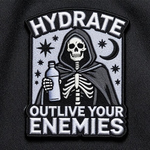 May include: Embroidered patch featuring a skeleton in a hooded cloak holding a water bottle. The patch has the words "HYDRATE" and "OUTLIVE YOUR ENEMIES" in white lettering. The design includes stars and a crescent moon on a black background.