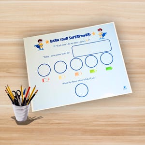 May include: A white reward chart with the text "EARN YOUR SUPERPOWER" and illustrations of a superhero. The chart includes spaces for tracking progress and the text "Each time I do my best, I earn a !" and "Today I earn power bolts for:"