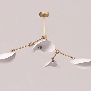 Stilinovo Style Sputnik Chandelier 4- Light Arm Brass Modern Lighting Mid-Century Aesthetic, Casting a Warm, Diffused Light.